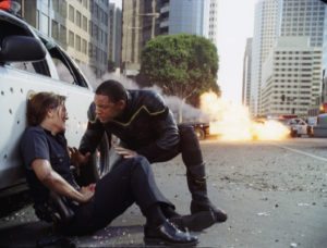 Hancock (Will Smith, right) saves the life of an injured female cop (Liz Wicker, left) before taking out a gang of heavily armed bank robbers in Columbia Pictures' Hancock. The film is directed by Peter Berg. The screenplay is by Vy Vincent Ngo and Vince Gilligan. The film is produced by Akiva Goldsman, Michael Mann, Will Smith, and James Lassiter. Hancock is set for release July 2, 2008.